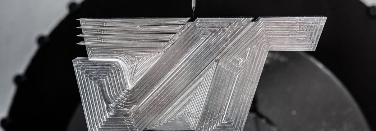 Photo of the Velocetec logo device being machined from solid metal