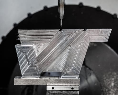 Photo of the Velocetec logo device being machined from solid metal